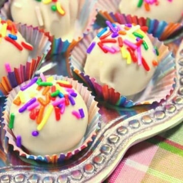 Closeup photo of no-bake shortbread cookie truffles with white chocolate and multi-colored sprinkles
