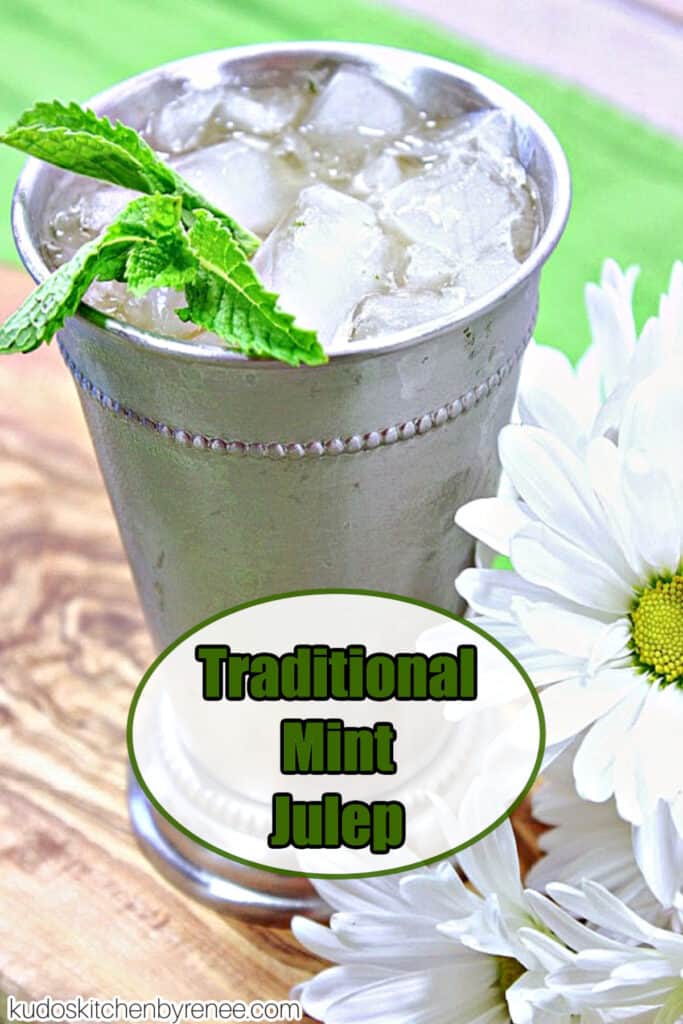 A vertical closeup of a Traditional Mint Julep along with white daisies and fresh mint.