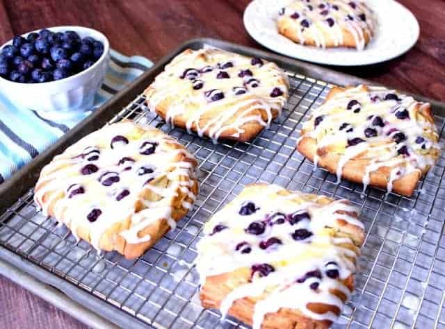 Blueberry Cheese Danish on a rack covered with a vanilla drizzle.