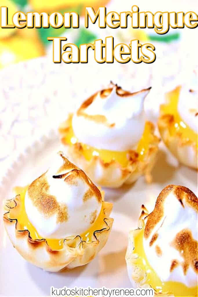A vertical closeup along with a title text overlay graphic for Lemon Meringue Tartlets with a toasted meringue top.