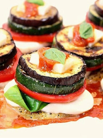 A Garden Harvest Polenta Stack with polenta, tomato, eggplant, basil and cheese.