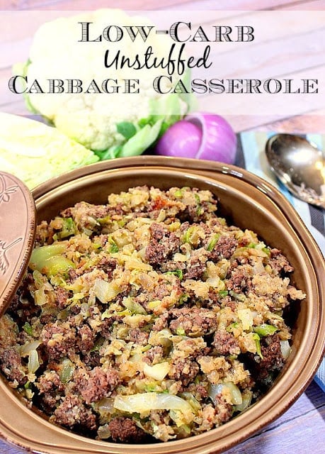 Low Carb Unstuffed Cabbage Casserole in a casserole dish along with a cauliflower and onion.