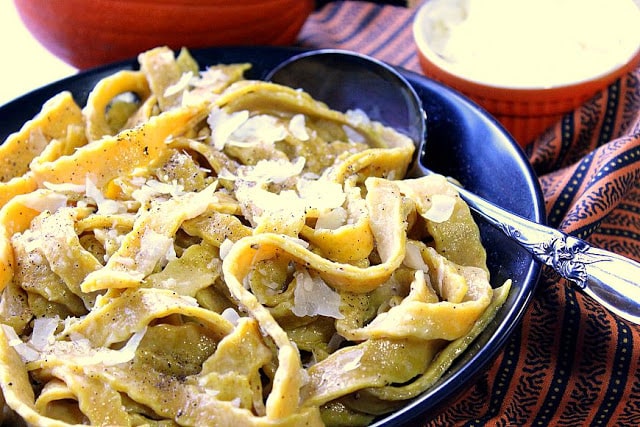 Homemade Pumpkin Pasta with Sage in a bowl with a spoon.