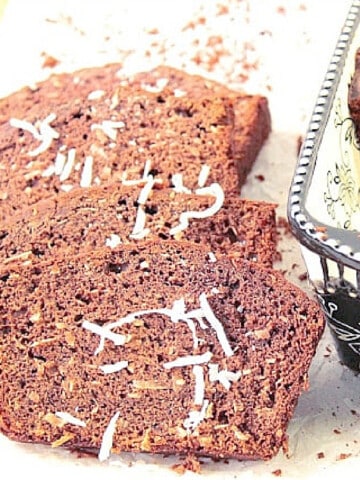 A few slices of Cocoa Coconut Banana Bread with some fresh coconut sprinkled on top.