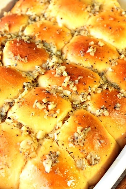 A baking dish filled with golden Garlic Yeast Rolls.