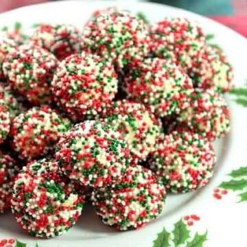 Christmas Cream Cheese Sprinkles Cookies on a holly berry plate