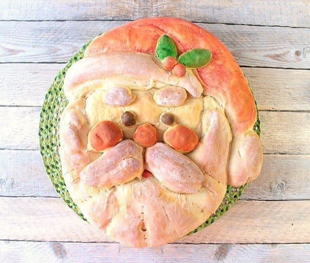 Overhead photo of a colorful buttermilk honey shaped santa bread.