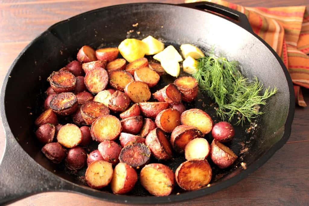 Crispy Red Potatoes with Lemon and Dill in a large cast iron skillet 