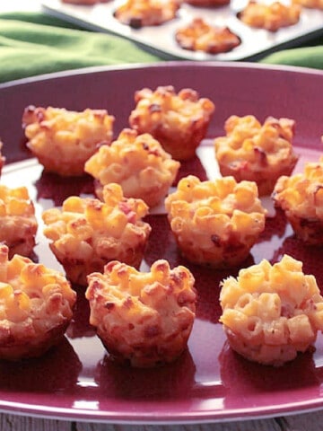 A bunch of Macaroni and Cheese Appetizer Bites on a football platter.