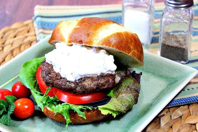 Lamb and Feta Burgers with Tzatziki Sauce on a green square plate.