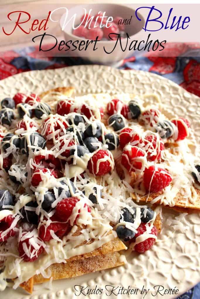 Closeup vertical image of cinnamon sugar dessert nachos topped with berries and white chocolate.