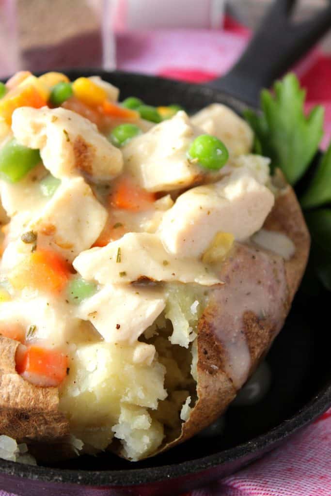 Closeup picture of chicken and vegetables in a baked potato.