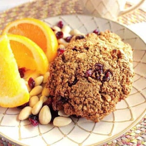 Two Gluten Free Breakfast Cookies on a plate with orange slices.