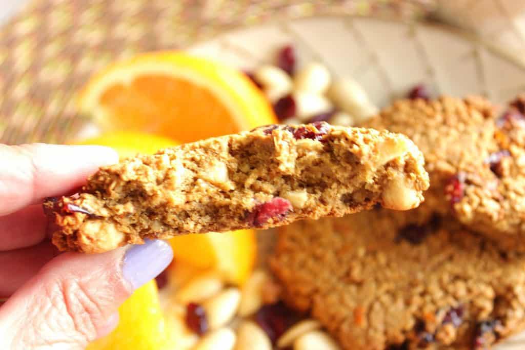 A horizontal photo of the inside of a gluten-free breakfast cookie with almonds and cranberries.
