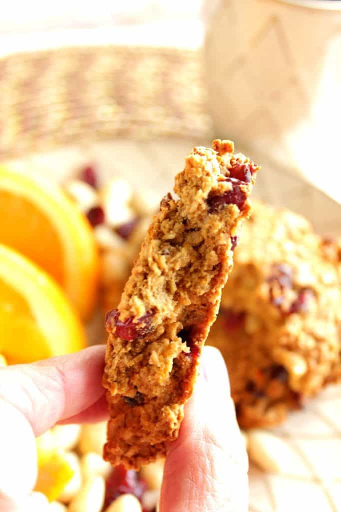 A closeup vertical photo of the inside of a gluten-free breakfast cookie with cranberries and almonds.