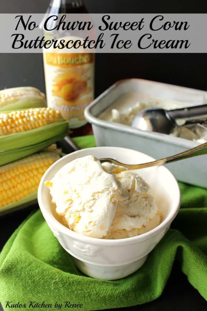 A vertical image of a bowl of no-churn roasted sweet corn ice cream in the foreground and some ears of corn in the background