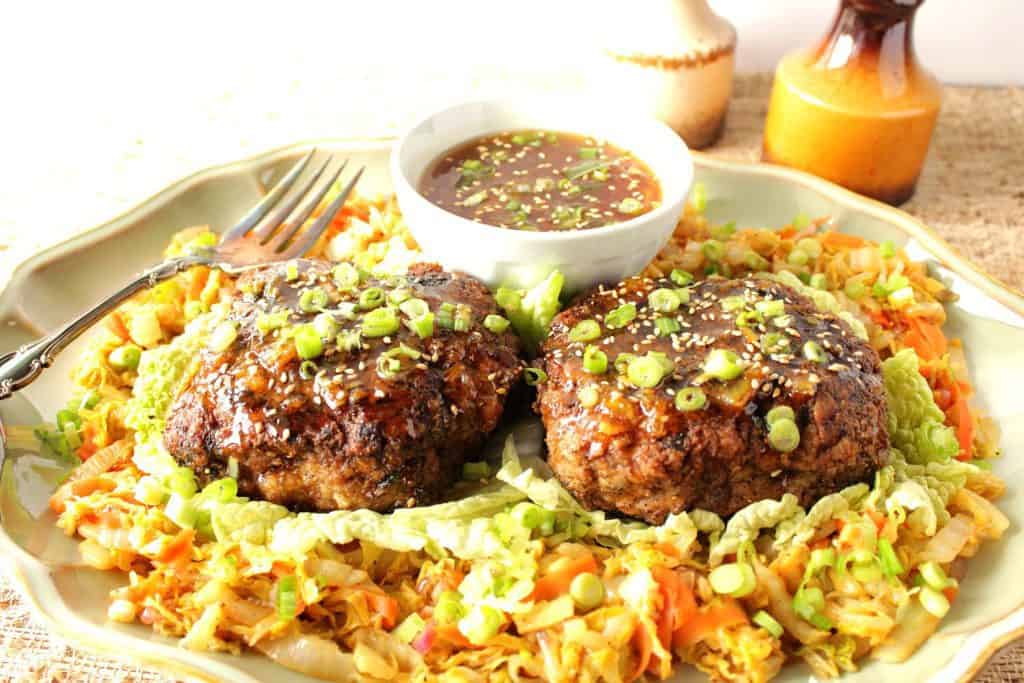 Colorful horizontal photo of two duck burgers on a plate with Asian cabbage with carrots and scallions.