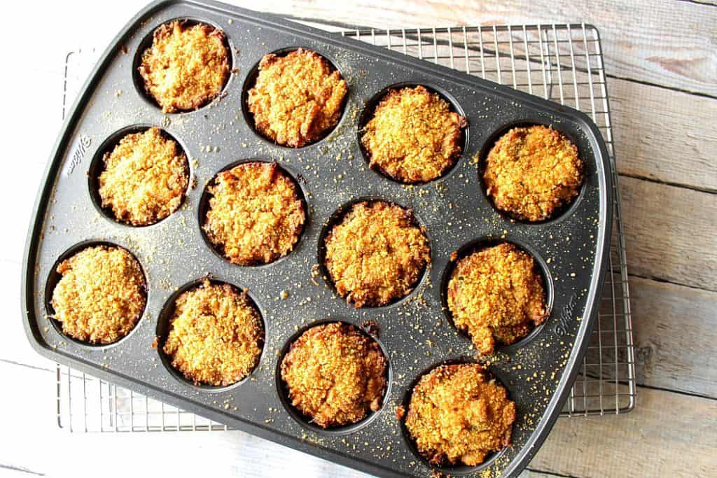 Overhead photo of muffin tin crab cakes in a muffin tin and on a wire rack.