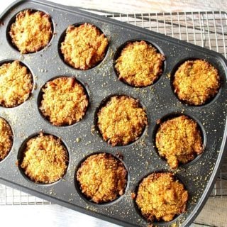 Overhead photo of muffin tin crab cakes in a muffin tin and on a wire rack.