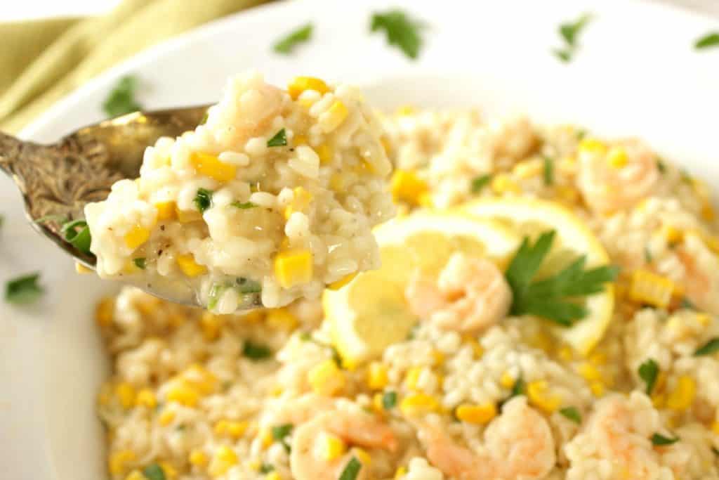 A closeup photo of a spoonful of Sweet Corn Risotto with Shrimp. Sweet Corn Recipe Roundup