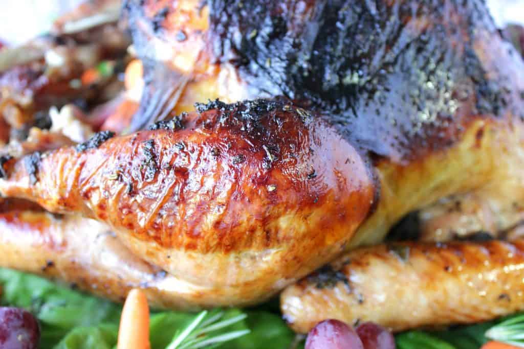 A closeup horizontal photo of a beautifully browned whole roast turkey.