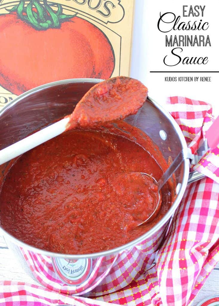 A spoon resting on the outside of a stockpot filled with classic marinara sauce with a ladle inside.