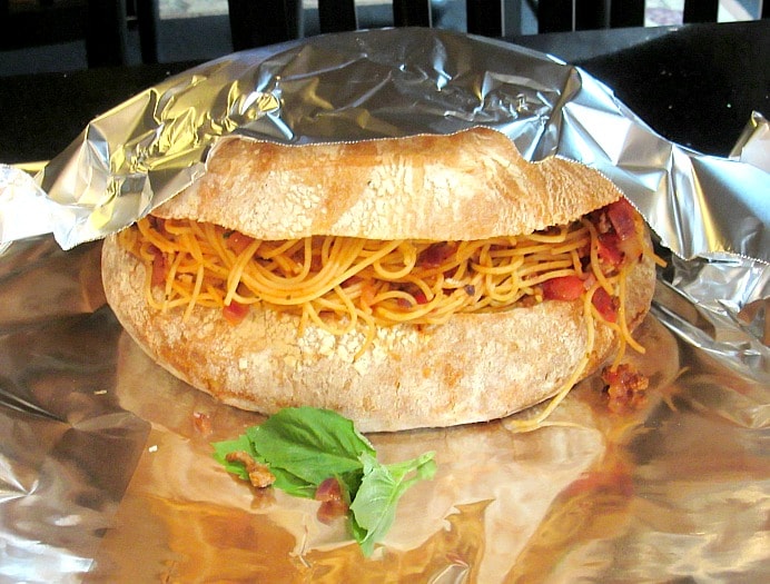 Spaghetti Stuffed Garlic Cheese Bread covered in aluminum foil.