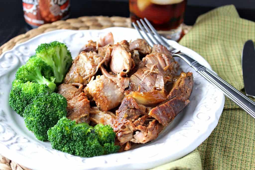 Root beer country ribs for the slow cooker on a plate with a fork and broccoli.