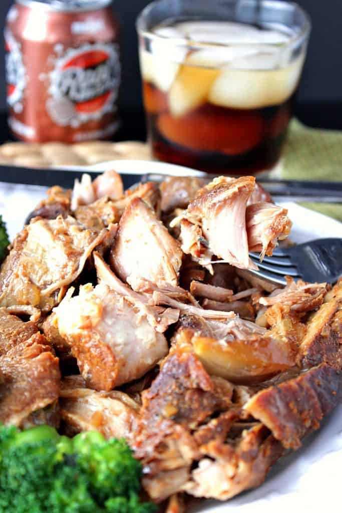 Root Beer Country Ribs for the Slow Cooker with a glass of root beer in the background.