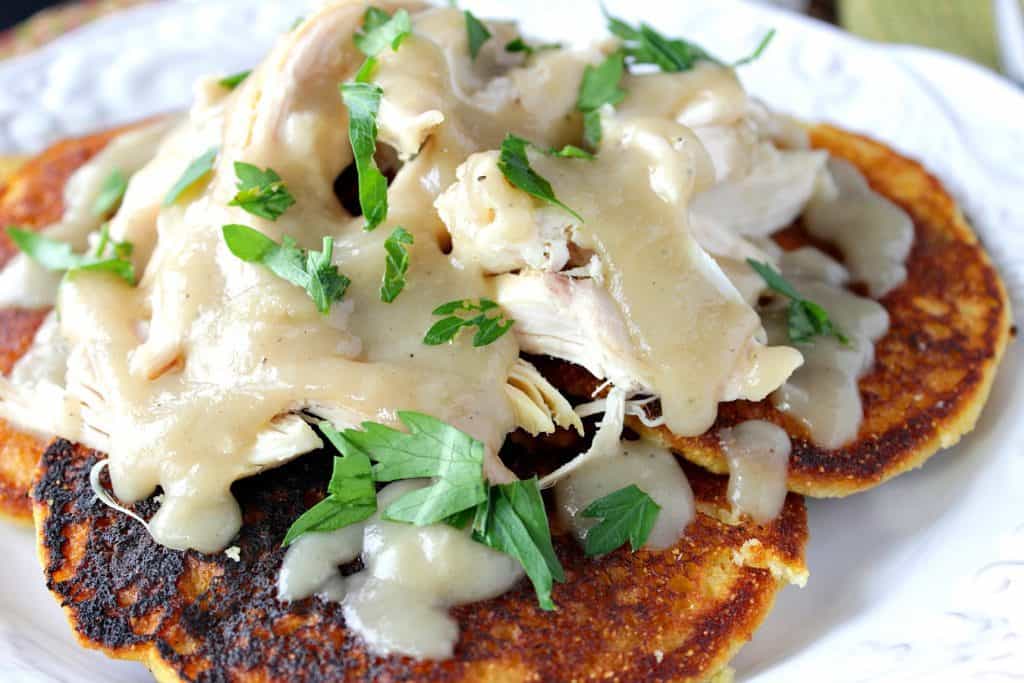 Closeup photo of Chicken and Chile Corn Cakes with Buttery Maple Gravy with fresh parsley garnish