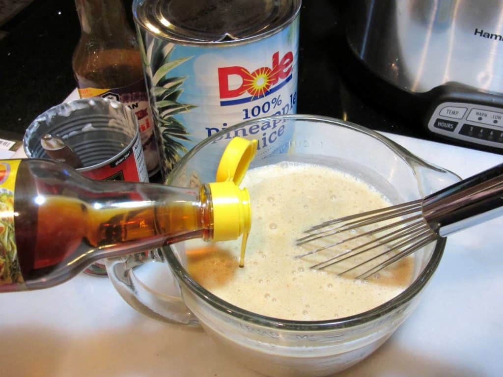 Sesame oil being added to a measuring cup.