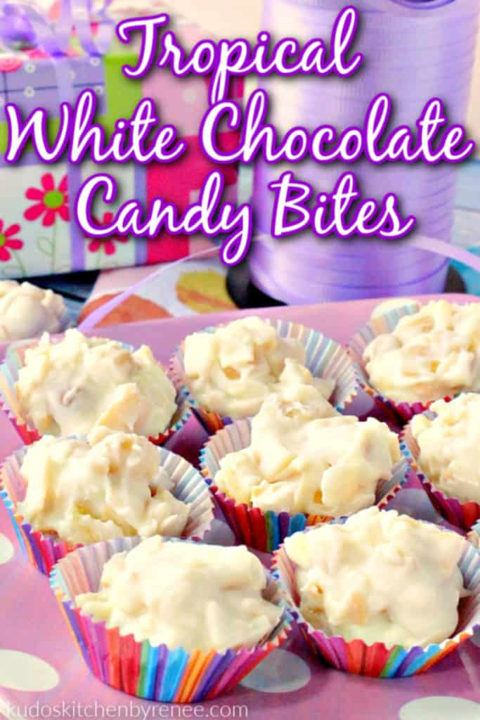 A vertical closeup photo of tropical white chocolate candy bites on a pink polka dot plate with title text graphic overlay