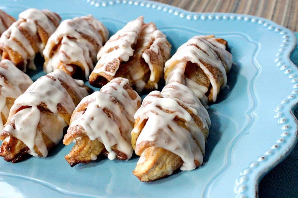 Apple Pie Wedges lined up on a blue scalloped plate