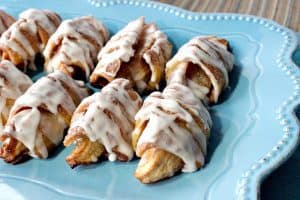 Apple Pie Wedges lined up on a blue scalloped plate