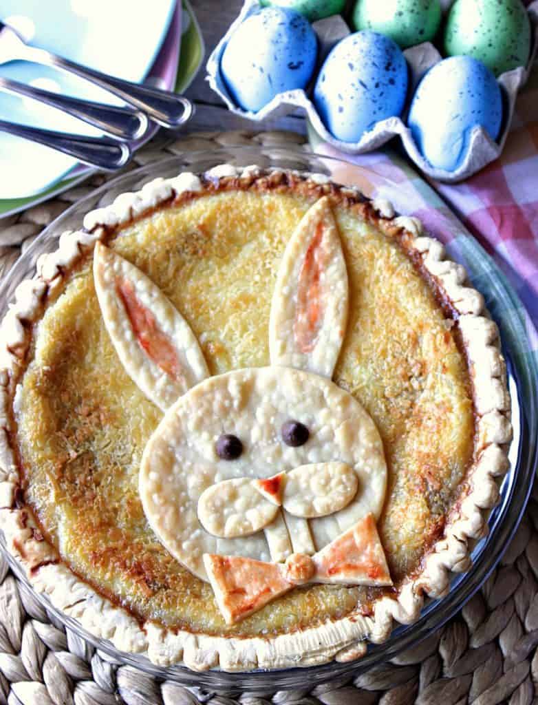 Overhead vertical image of coconut custard easter bunny pie with bunny crust.