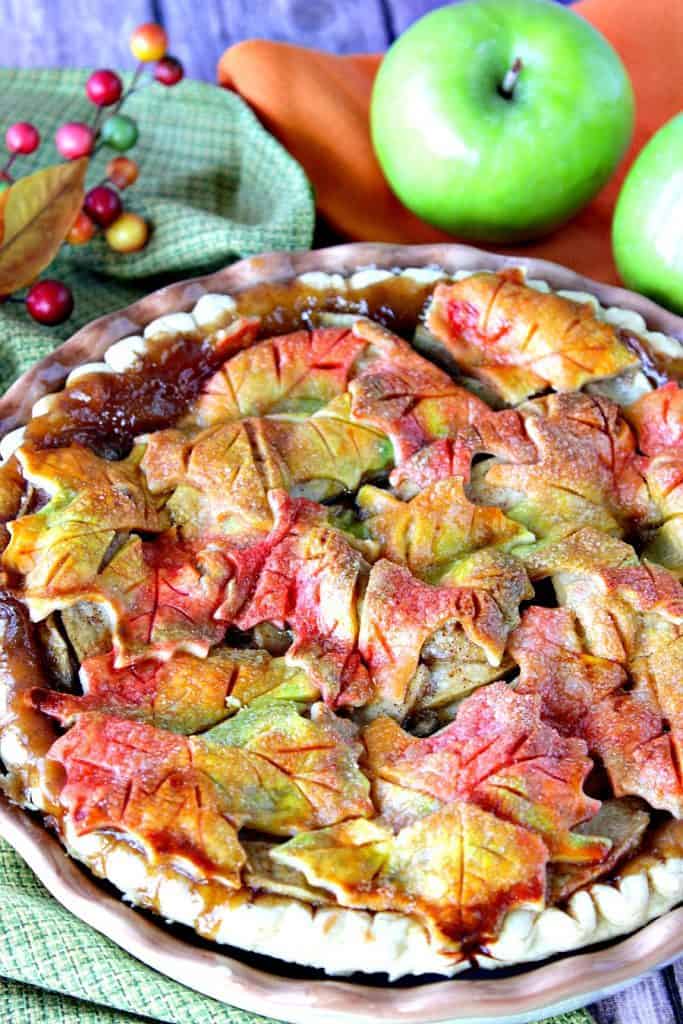 Closeup vertical image of Autumn Leaves Apple Pie with a colorful crust.