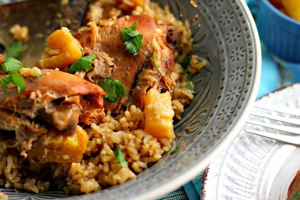 Hawaiian Pineapple Chicken Thighs with rice in a blue bowl.