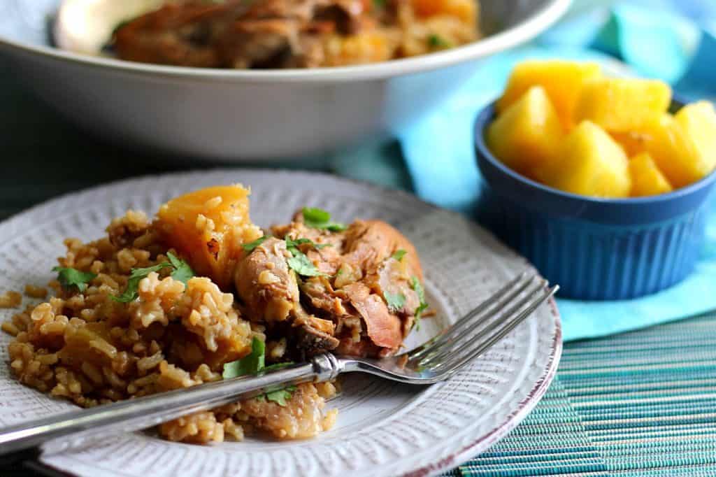 Hawaiian Pineapple Chicken Thighs on a plate with a fork.