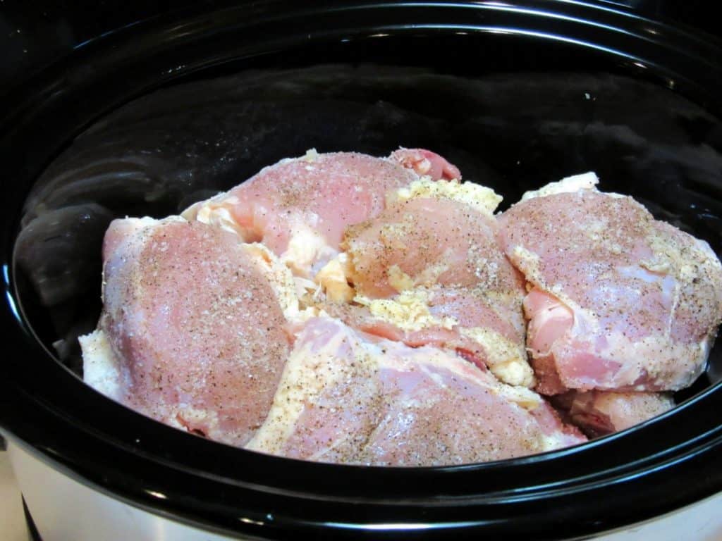 Chicken thighs in a slow cooker.