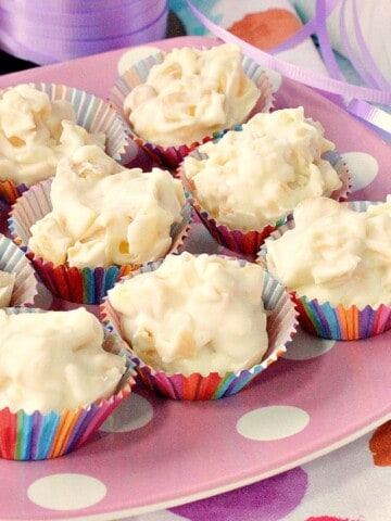 A bunch of Tropical White Chocolate Candy Bites on a pink and white polka dot plate.