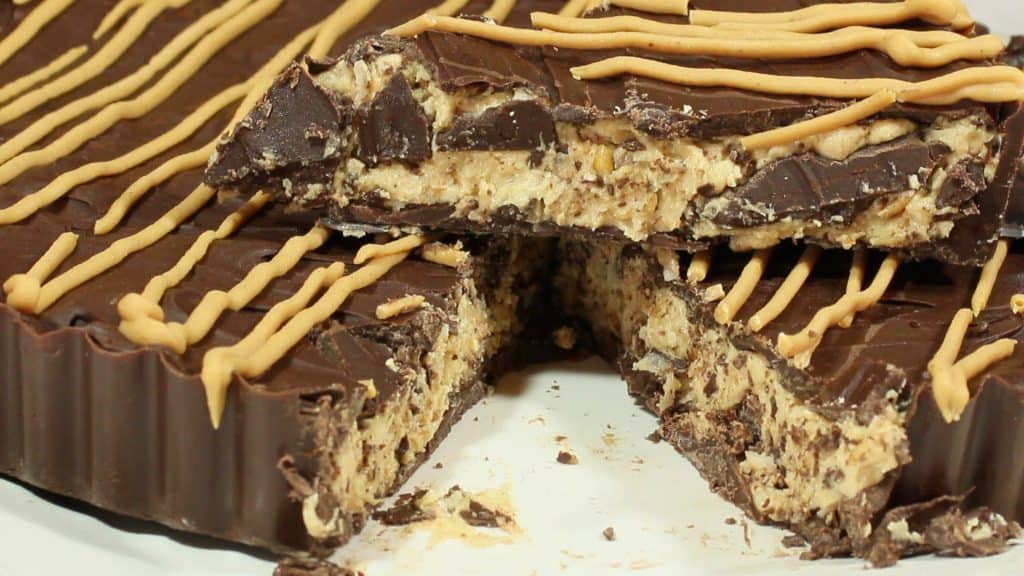 Closeup horizontal photo of a Giant Peanut Butter Cup with a slice taken out.