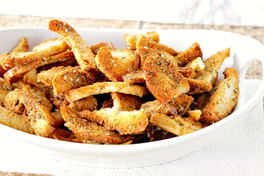 A white bowl filled with everything crunchy bagel chips.