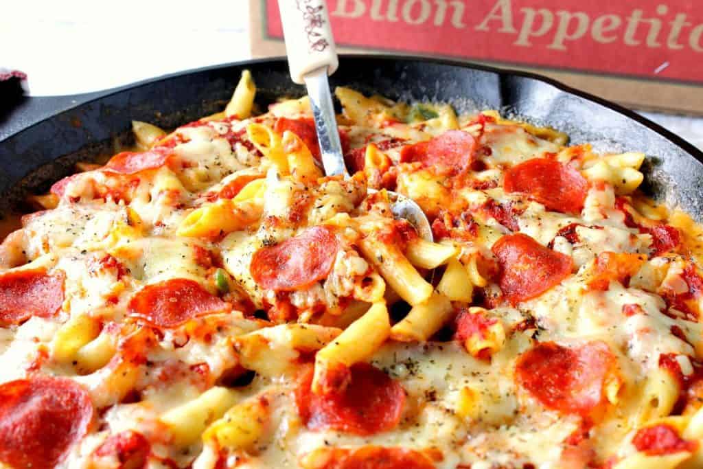 Pepperoni Pizza Macaroni and Cheese with a pizza box and spoon.