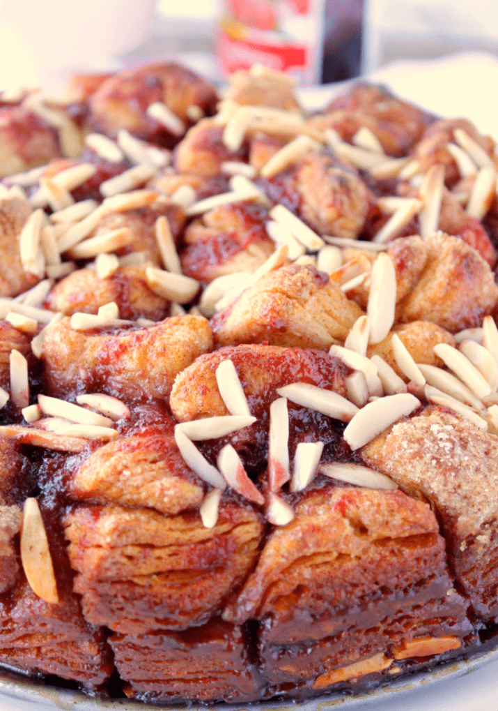 Vertical closeup of monkey bread with raspberry and almonds