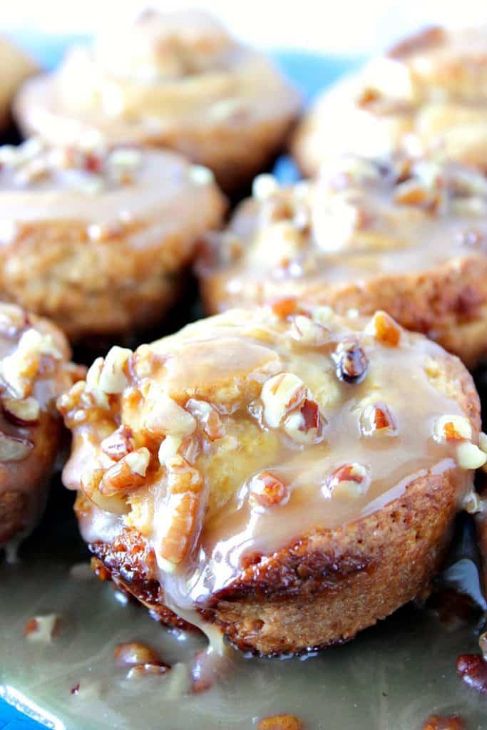 If you love using the pop tube crescent rolls, then you'll love these Homemade Sticky Caramel Sweet Rolls! The dough is sweet and easy to make. It requires no rise time and only a few minutes of light kneading. Plus it tastes just like the pop tube crescent rolls, only better! - Kudos Kitchen by Renee Close up picture of a sticky caramel sweet roll with pecans