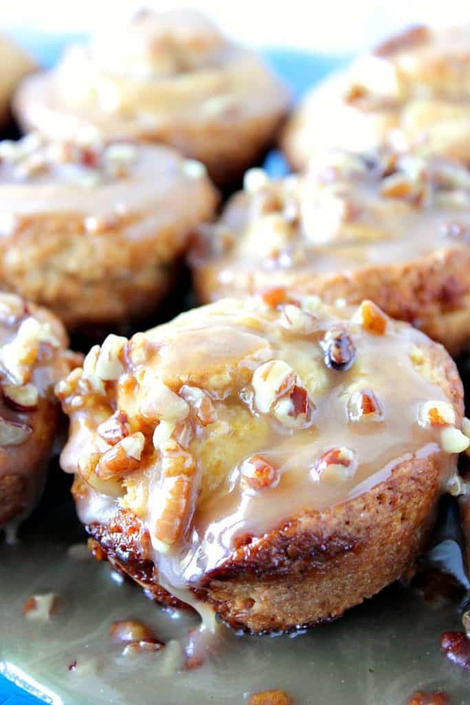 Close up picture of a sticky caramel sweet roll with pecans