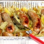 One Pan Italian Sausage Fennel & Potato Dinner in an aluminum pan with a large serving spoon.