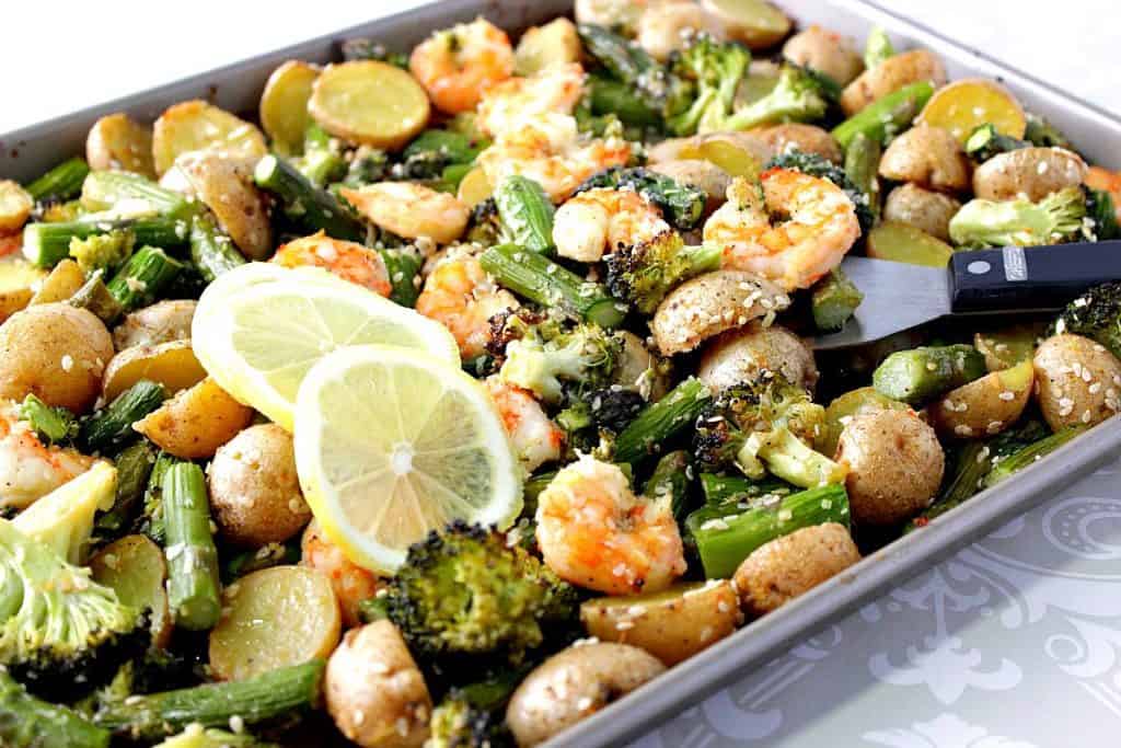 Sheet pan filled with broccoli, shrimp, asparagus and potatoes.