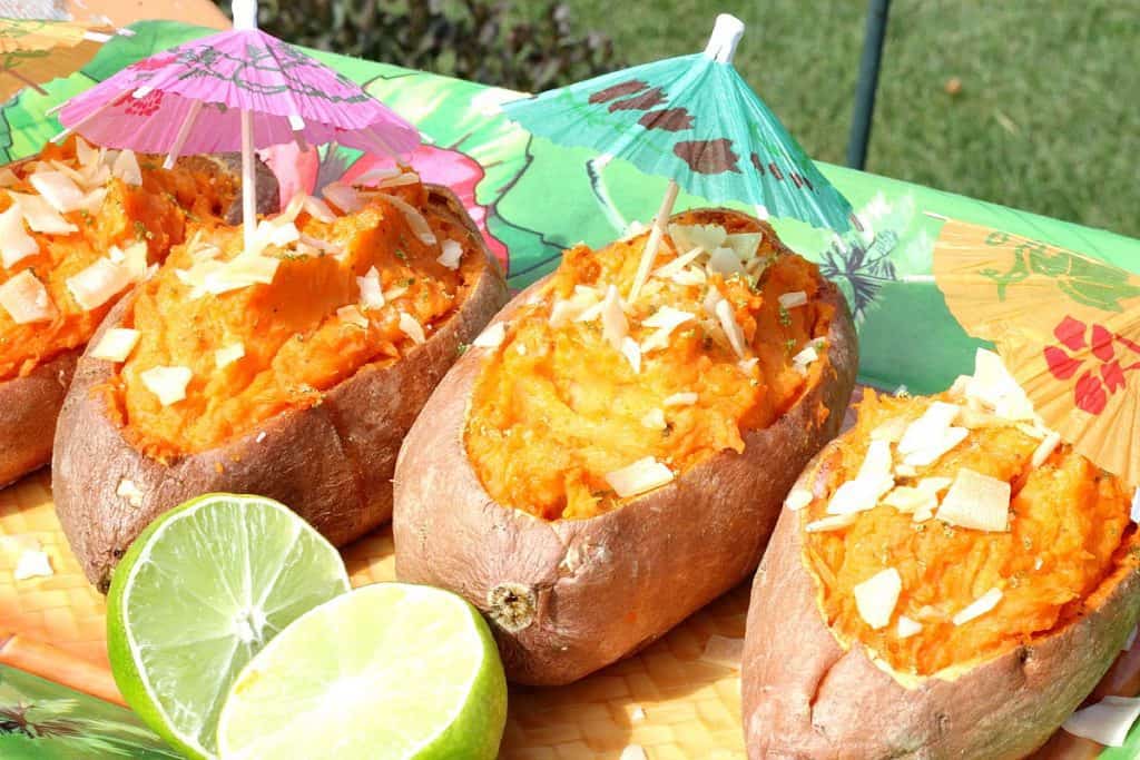 Colorful sweet potatoes on a tropical theme plate with paper umbrellas.