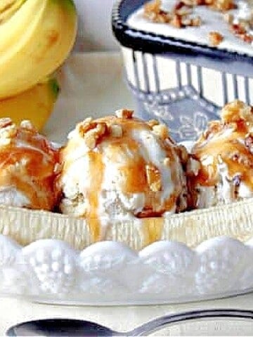 Three scoops of Banana Walnut Ice Cream in a long white dish with a sliced banana.